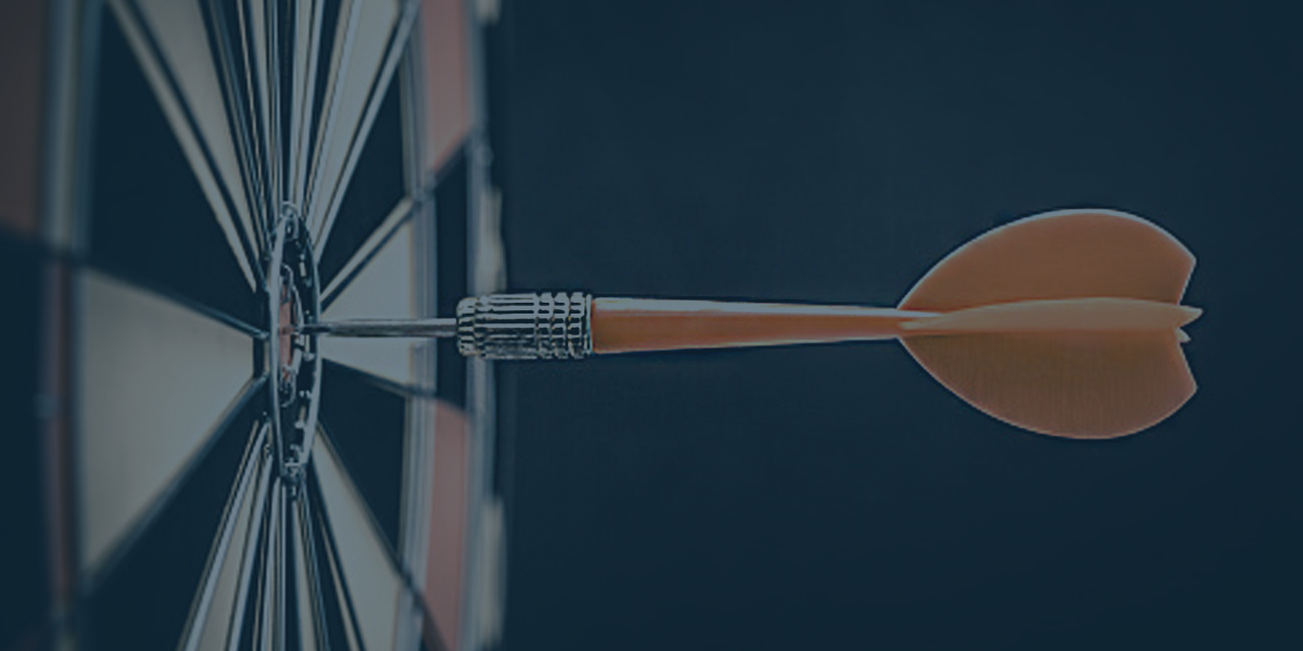 A dart board with a dart in the bullseye.